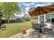 Green backyard featuring an umbrella, table, chairs, and a clear view of the house at 1310 Belhaven Dr, Mount Pleasant, SC 29466