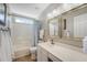 Bright bathroom featuring a vanity with a white countertop, framed mirrors and a shower-tub combo with a blue shower curtain at 1310 Belhaven Dr, Mount Pleasant, SC 29466