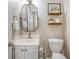 Well-lit half bathroom featuring a modern sink, decorative mirror, and stylish shelves at 1310 Belhaven Dr, Mount Pleasant, SC 29466