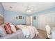 Bright bedroom with a cozy bed, art-filled walls, and convenient closet space at 1310 Belhaven Dr, Mount Pleasant, SC 29466