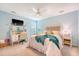 Charming bedroom featuring a cozy desk, a TV, and a comfortable bed with teal accents at 1310 Belhaven Dr, Mount Pleasant, SC 29466