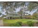 Beautifully landscaped clubhouse with a manicured lawn and mature trees in a golf community at 1310 Belhaven Dr, Mount Pleasant, SC 29466