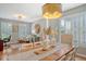Dining room features a farmhouse table, shutters, and an ornate chandelier at 1310 Belhaven Dr, Mount Pleasant, SC 29466