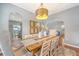 Open dining room boasts a farmhouse table, chandelier, and neutral decor at 1310 Belhaven Dr, Mount Pleasant, SC 29466