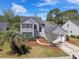 Charming two-story home with basketball hoop, landscaped yard, and a welcoming walkway to the front door at 1310 Belhaven Dr, Mount Pleasant, SC 29466