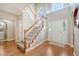 Grand foyer featuring hardwood floors, staircase with wood railings, and plenty of natural light from the arched window at 1310 Belhaven Dr, Mount Pleasant, SC 29466