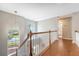 Bright hallway featuring hardwood floors, white banister, and arched windows at 1310 Belhaven Dr, Mount Pleasant, SC 29466
