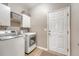 Efficient laundry room with modern washer, dryer, and convenient overhead storage at 1310 Belhaven Dr, Mount Pleasant, SC 29466