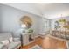 Open living room with accent chair, hardwood floors, and sight lines to dining room at 1310 Belhaven Dr, Mount Pleasant, SC 29466