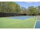 Tennis court surrounded by a black fence, and mature trees in an active community at 1310 Belhaven Dr, Mount Pleasant, SC 29466