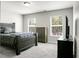 This bedroom boasts natural light with its two windows and a neutral color palette at 1314 Garland St, North Charleston, SC 29420