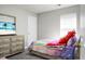 Charming bedroom with colorful bedding, dresser and a tv with a beach image displayed at 1314 Garland St, North Charleston, SC 29420