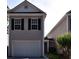Charming home featuring a two-car garage and neatly landscaped front yard with a manicured bush near the front entrance at 1314 Garland St, North Charleston, SC 29420