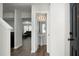 Bright hallway featuring wood flooring, a half bathroom, and an open view to the living room at 1314 Garland St, North Charleston, SC 29420