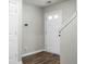 Bright hallway with wood flooring leading to a white door and staircase at 1314 Garland St, North Charleston, SC 29420
