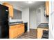Kitchen with wooden cabinets, black appliances and countertops, and hardwood floors at 1314 Garland St, North Charleston, SC 29420