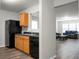 Well-lit kitchen with wood cabinets and black appliances, open to a spacious living area at 1314 Garland St, North Charleston, SC 29420