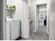 Bright laundry room with shelving above a modern, front-loading washer and dryer at 1314 Garland St, North Charleston, SC 29420