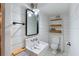 Bright white bathroom features a standing sink, shelving and toilet at 1316 Thompson, Sullivans Island, SC 29482