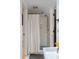 Shower features subway tile, blue accent floor and a curtain with tassel trim at 1316 Thompson, Sullivans Island, SC 29482