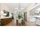 Bright open-concept dining area with vaulted ceilings, chandelier, and seamless flow to the kitchen at 1316 Thompson, Sullivans Island, SC 29482