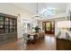 Formal dining room with wood floors, vaulted ceilings, statement lighting, and view into modern kitchen at 1316 Thompson, Sullivans Island, SC 29482