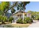 Charming home with a welcoming front porch, beautifully landscaped yard, and mature trees at 1316 Thompson, Sullivans Island, SC 29482