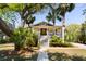 Charming two-story home with a welcoming front porch, lush landscaping, and mature trees at 1316 Thompson, Sullivans Island, SC 29482