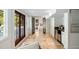 Hallway features tiled floor, bar with stainless steel refrigerator and access to outdoors at 1316 Thompson, Sullivans Island, SC 29482