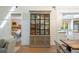 Open-concept living area with display cabinet and view into bedroom and modern kitchen at 1316 Thompson, Sullivans Island, SC 29482
