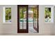 Covered outdoor living area overlooks the pool and the lush green landscaping at 1316 Thompson, Sullivans Island, SC 29482