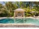 Beautiful pool and cabana surrounded by tropical landscaping and lounge chairs at 1316 Thompson, Sullivans Island, SC 29482