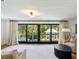 Cozy sunroom featuring large windows with views of lush greenery and comfortable furniture at 1316 Thompson, Sullivans Island, SC 29482