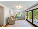 Sitting room with an accent table and bright views of outdoor greenery and sunlight at 1316 Thompson, Sullivans Island, SC 29482