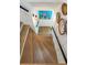 View of a wooden staircase with white shiplap and black railing with natural fiber wall decor at 1316 Thompson, Sullivans Island, SC 29482