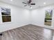 A bright bedroom with hardwood floors and windows provides a cozy atmosphere at 132 Tranquil Ln, Ladson, SC 29456