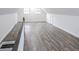 Bright bonus room featuring wood floors, white walls, and natural light from two windows at 132 Tranquil Ln, Ladson, SC 29456