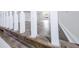 Close-up of a staircase with white wood and railing, and view of bonus room with wood floors at 132 Tranquil Ln, Ladson, SC 29456