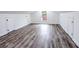 Bright bonus room with hardwood floors, three storage doors, and natural light from window at 132 Tranquil Ln, Ladson, SC 29456