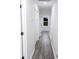 A hallway features hardwood floors, white walls, and closet doors along its length at 132 Tranquil Ln, Ladson, SC 29456