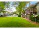 Beautiful condo backyard with lush green grass and community pool with fencing and outdoor furniture at 1402 Camp Rd # 10C, Charleston, SC 29412