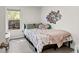 Cozy bedroom with a floral comforter, photos on the wall, and a large window at 1402 Camp Rd # 10C, Charleston, SC 29412