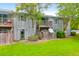 Charming condo building featuring balconies, gray siding, well-maintained landscaping and a lush green lawn at 1402 Camp Rd # 10C, Charleston, SC 29412