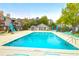 Relax in this community pool with lounge chairs, umbrellas, and lush landscaping in a beautiful condo community at 1402 Camp Rd # 10C, Charleston, SC 29412