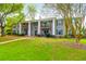Condo exterior featuring balconies, gray siding, well-maintained landscaping, and a beautiful green lawn at 1402 Camp Rd # 10C, Charleston, SC 29412