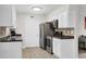 Well-equipped galley kitchen with modern appliances, white cabinets, and efficient layout maximizes space and functionality at 1402 Camp Rd # 10C, Charleston, SC 29412