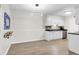 Eat-in kitchen area featuring modern white cabinets, sleek countertops, and stainless steel appliances, adjacent to dining area at 1402 Camp Rd # 10C, Charleston, SC 29412