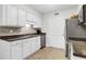 Galley kitchen boasts white cabinets, stainless steel appliances, and modern fixtures with lots of counter space at 1402 Camp Rd # 10C, Charleston, SC 29412
