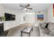 Open concept living room boasts modern furnishings, sleek flooring, and ample natural light and a large fireplace at 1402 Camp Rd # 10C, Charleston, SC 29412
