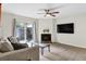 Inviting living room with comfortable seating, modern furnishings, and a cozy fireplace, with outside patio access at 1402 Camp Rd # 10C, Charleston, SC 29412